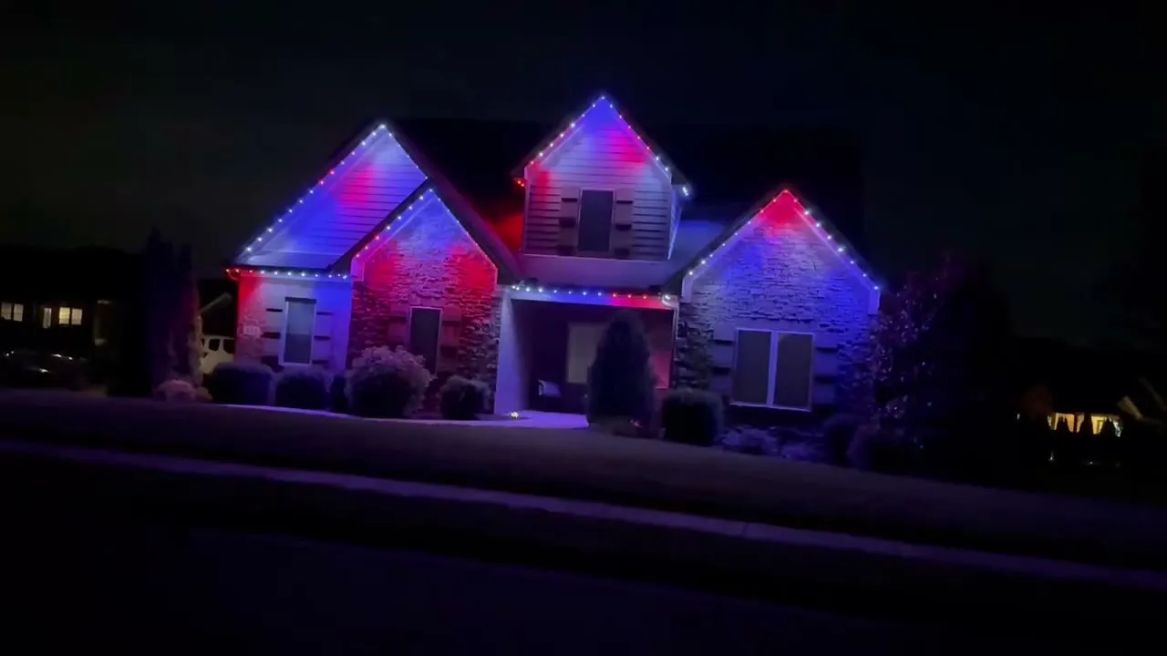 Home lit in red, blue and pink permanent lights for a holiday light show