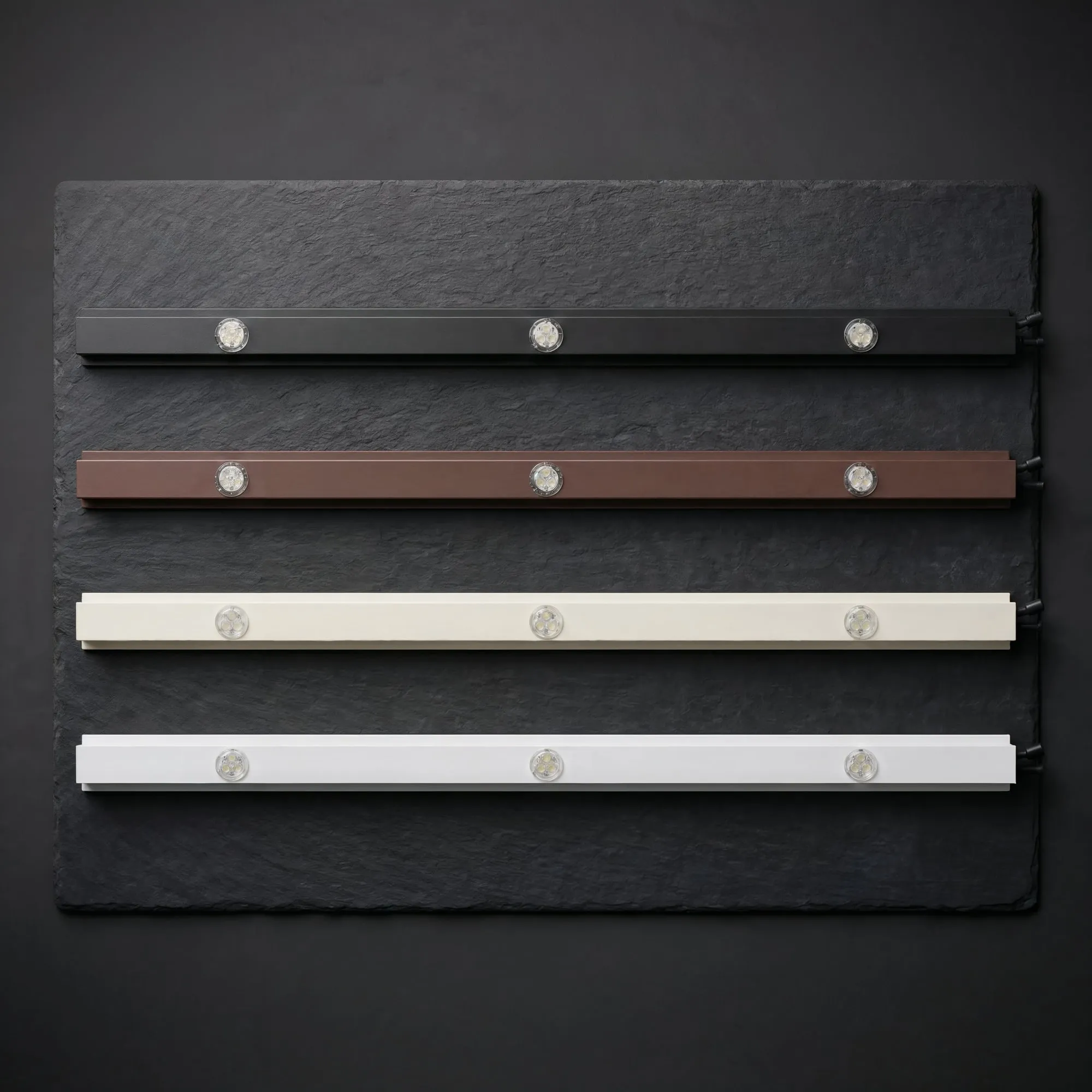 Permanent light track samples in matte black, brown, oyster white and white with LED lights in each